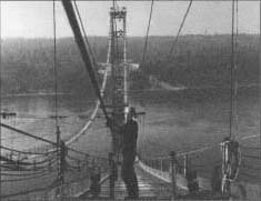 A steel worker lying cable stands for the suspension cable of the new Tacoma, Washington, Narrows Bridge on October 21, 1949.